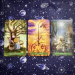 Three tarot cards, the Queen of Pentacles, Ace of Wands, and the Star