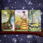 The tarot cards The World, Seven of Pentacles and Temperance